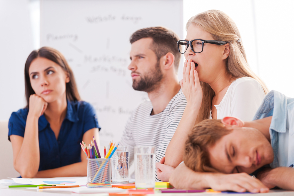 Group of professionals sitting in a boring meeting
